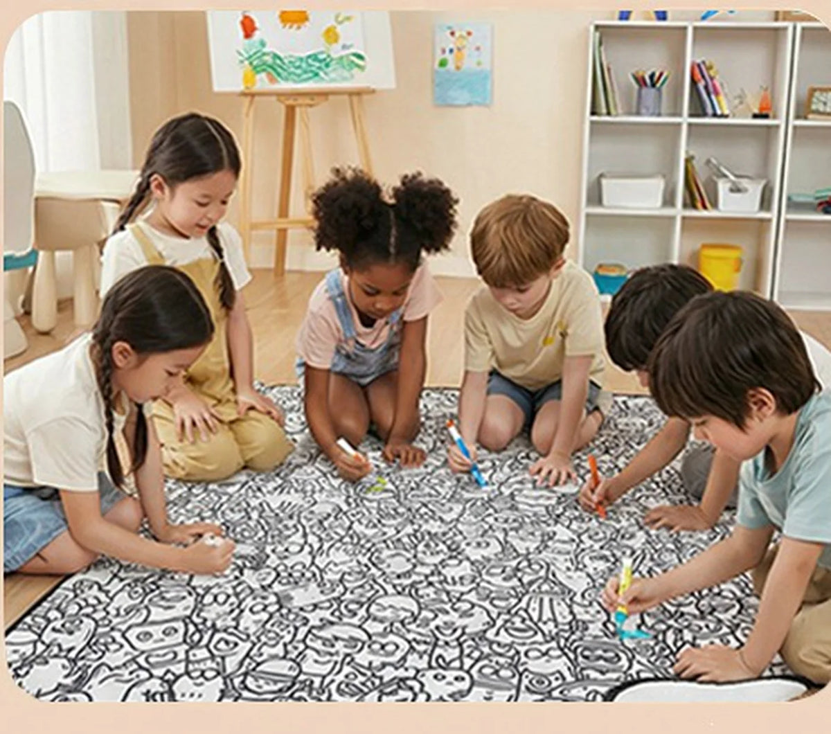 Children colouring the Tinta Blanket together on the floor