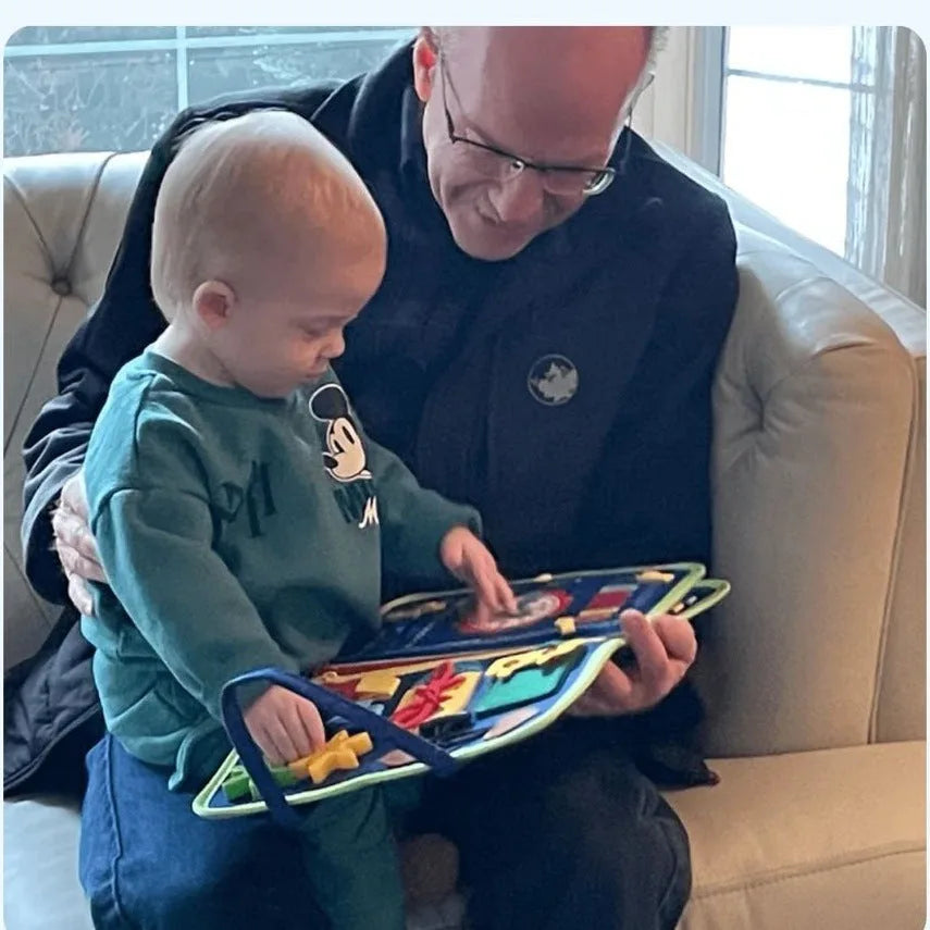 A grandad and his grandson exploring the busy board