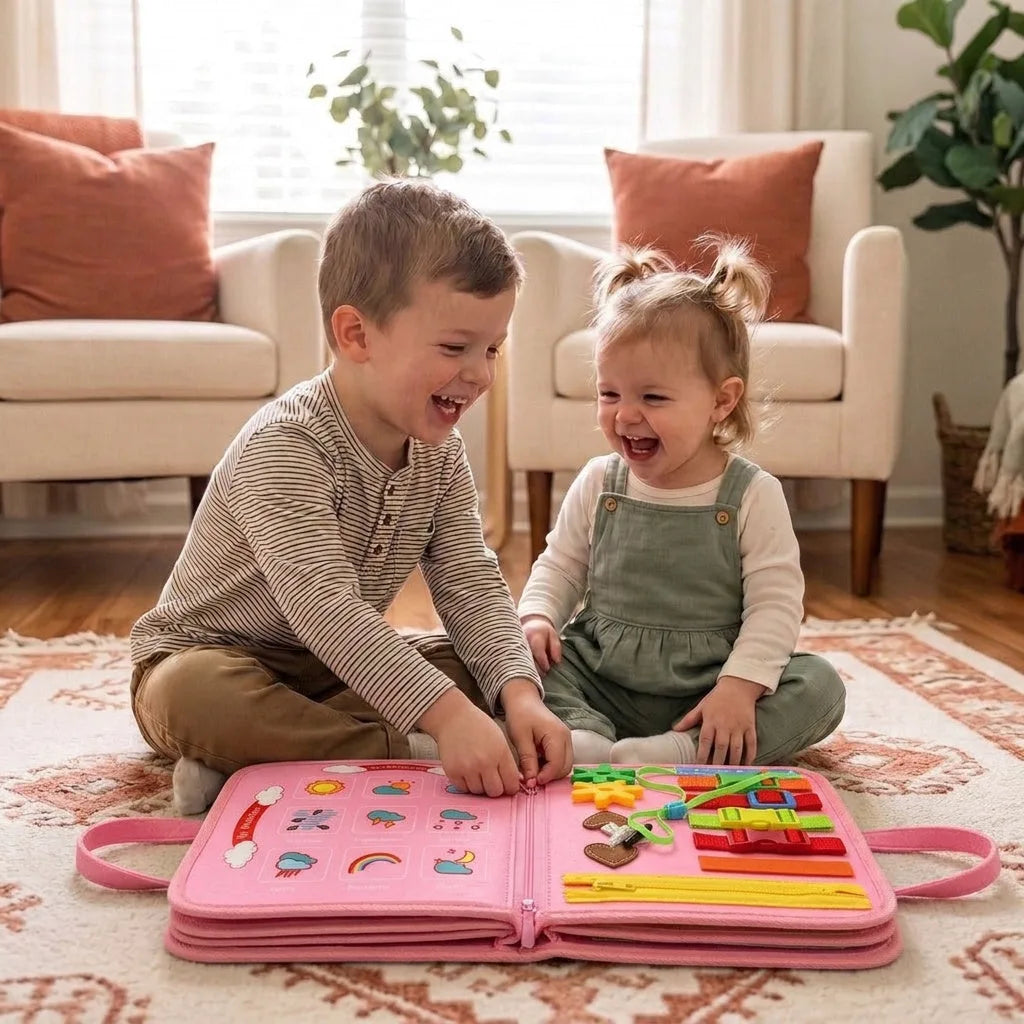 Brother and sister laughing around the pink Lysby busy board